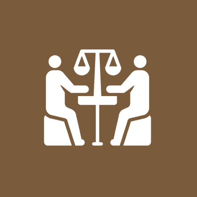 Two figures discussing at a table.