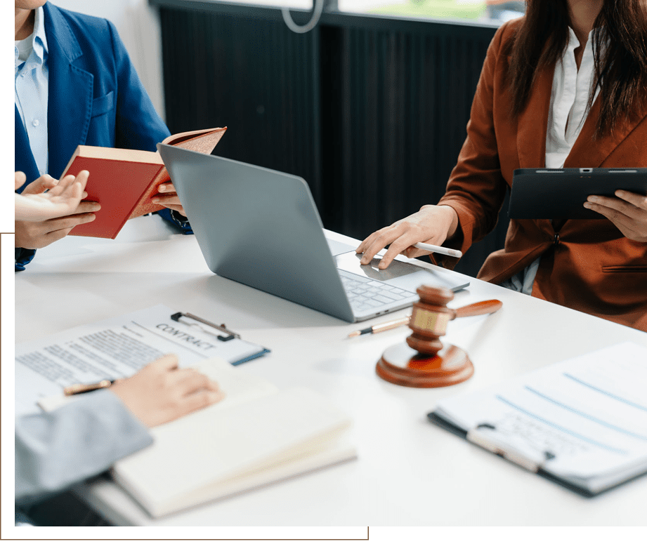 Legal professionals collaborating at office meeting table.